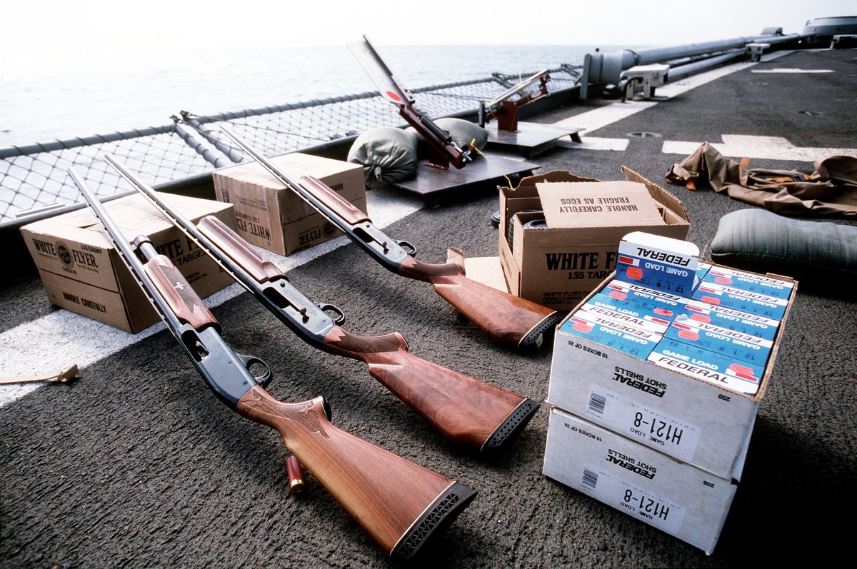 Break-action shotgun laid out for inspection