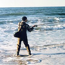 Surfcaster fishing the beach break