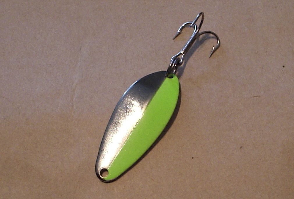 Casting spoon lure showing its curved metal body