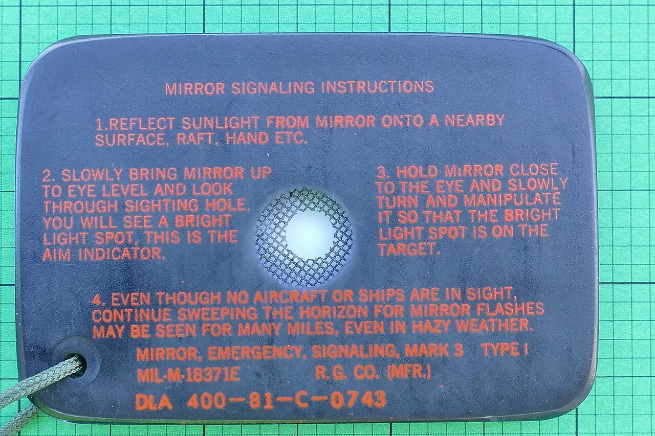 Military signal mirror with printed aiming instructions