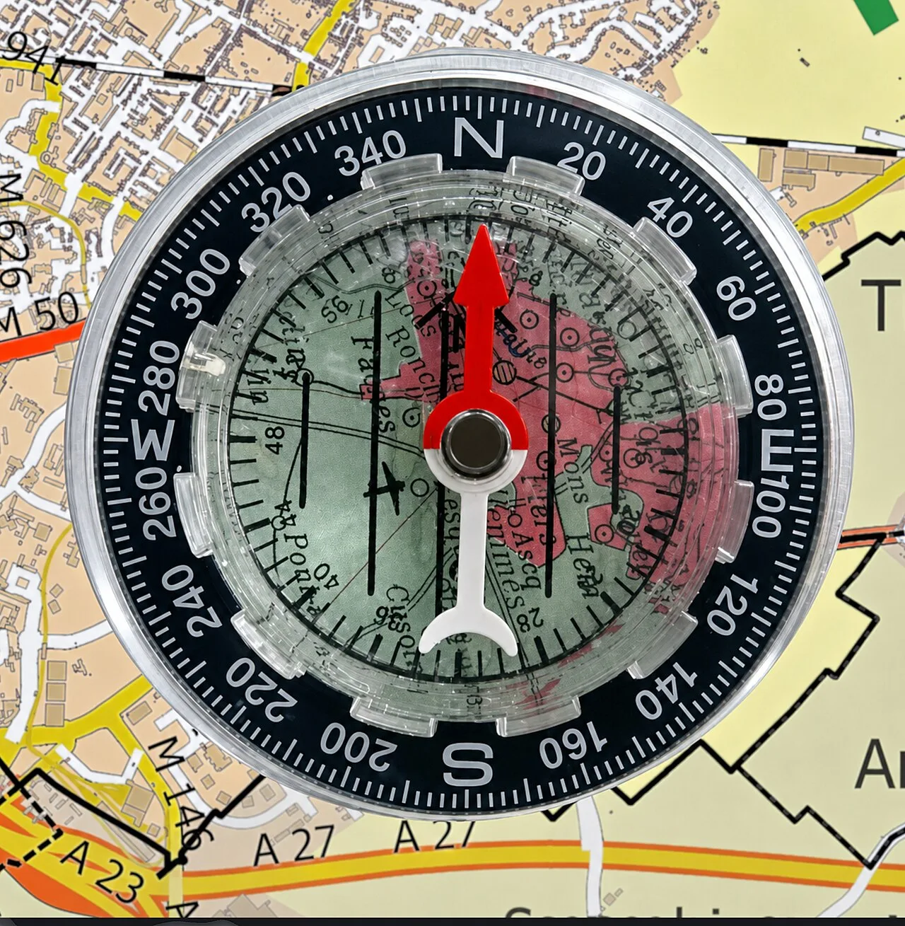 Baseplate compass lying on a topographic map